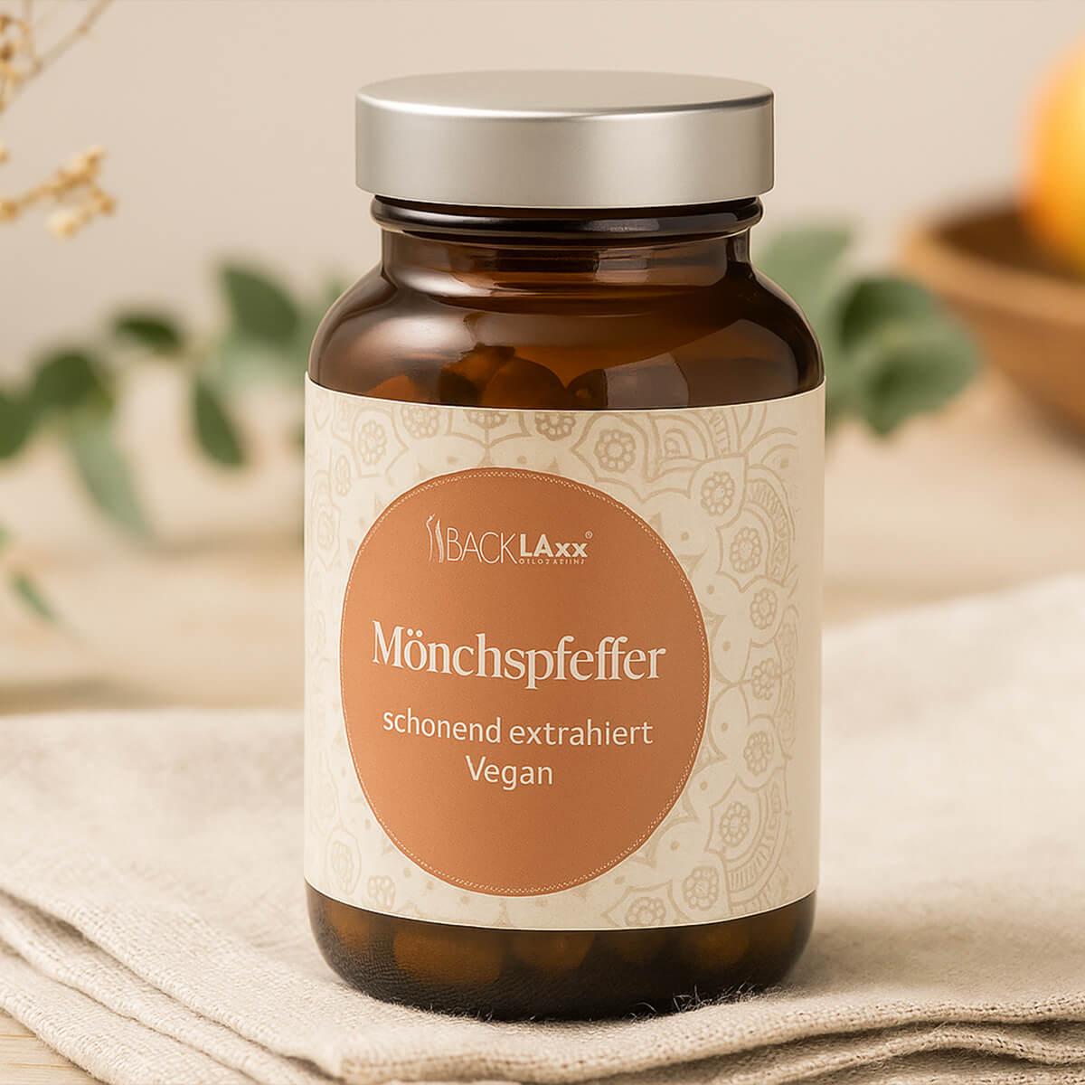 Dunkle BACKLAXX Mönchspfeffer Glasflasche mit silbernem Deckel als Lifestyle-Darstellung
